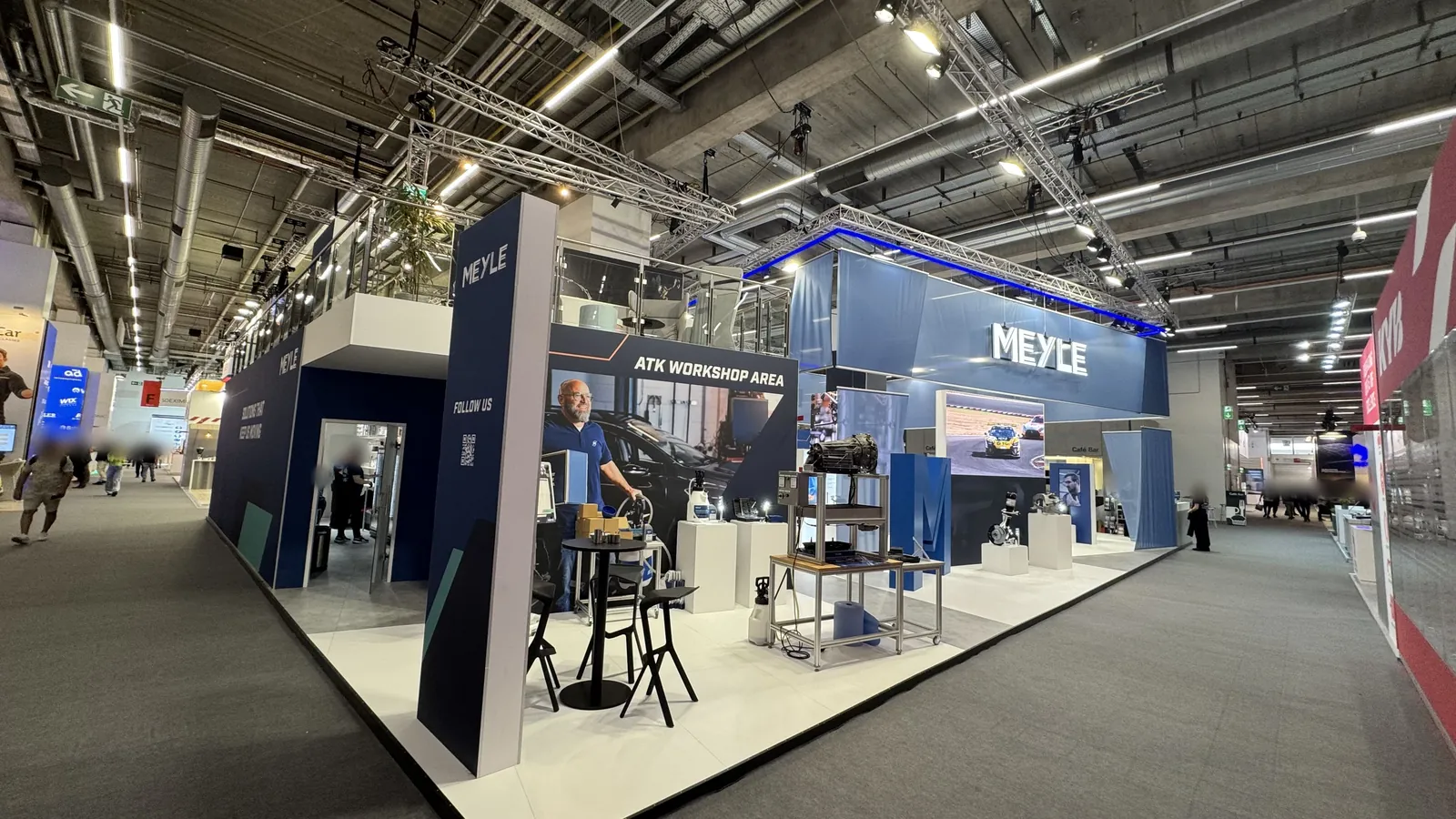 A large MEYLE exhibition stand in an exhibition hall, with trusses beneath the hall ceiling